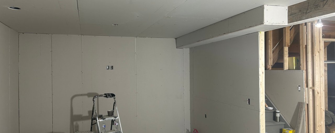 Finished basement living area with comfortable seating